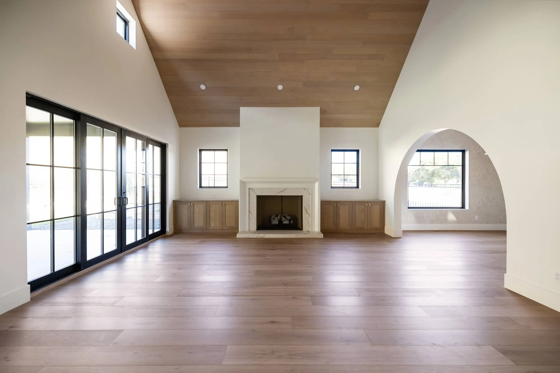 Living room with modern arched walls in custom home