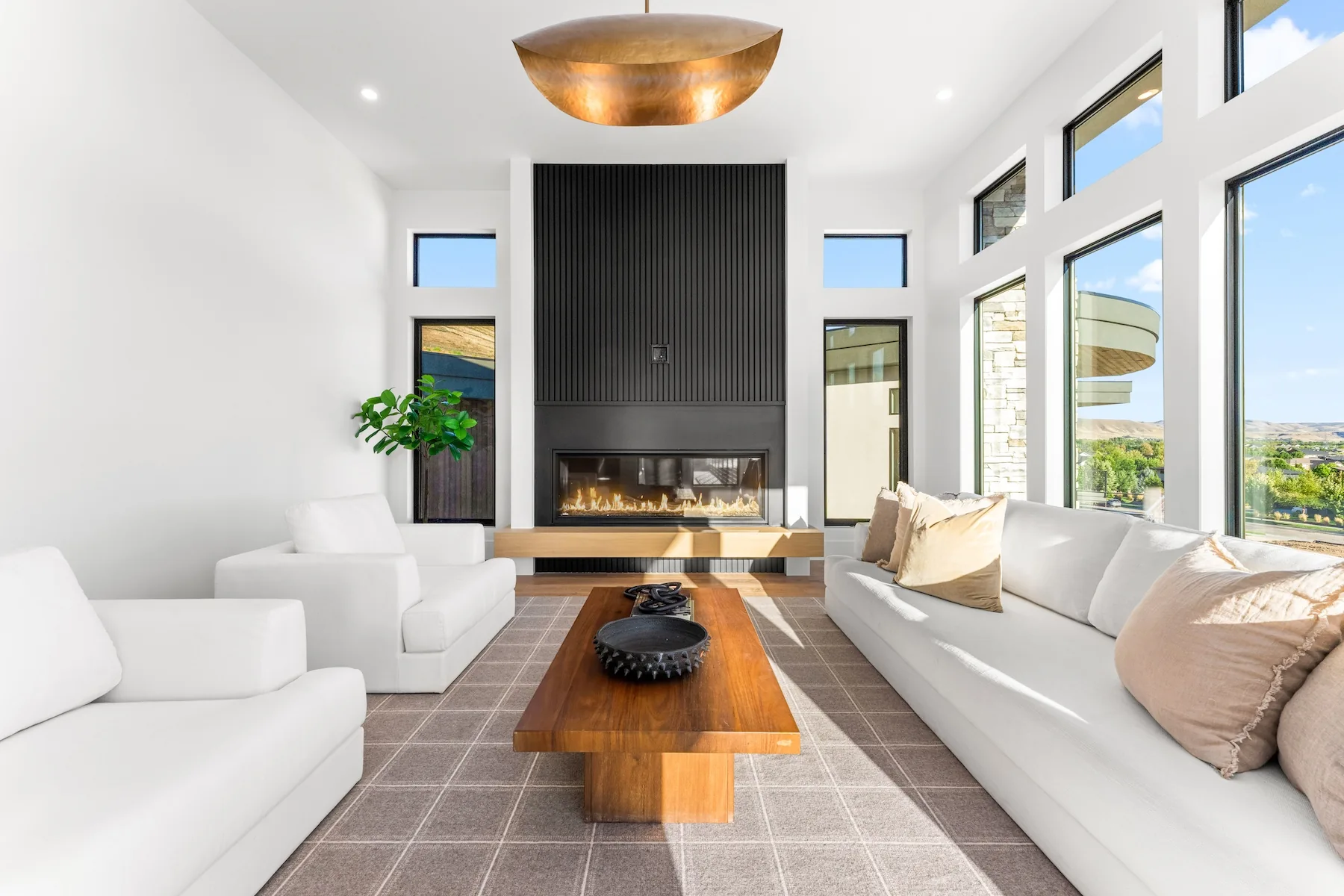 Living room with white accents and couches and bronze accents