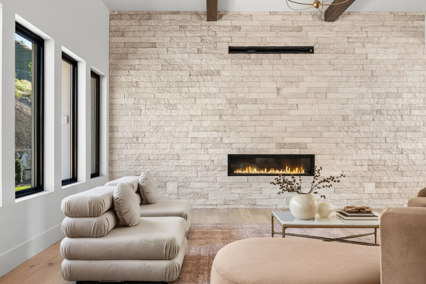White stone fireplace hearth with couches