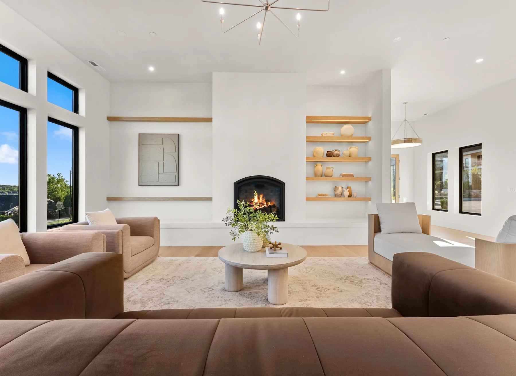 upstairs living room with wood shelves and a fireplace