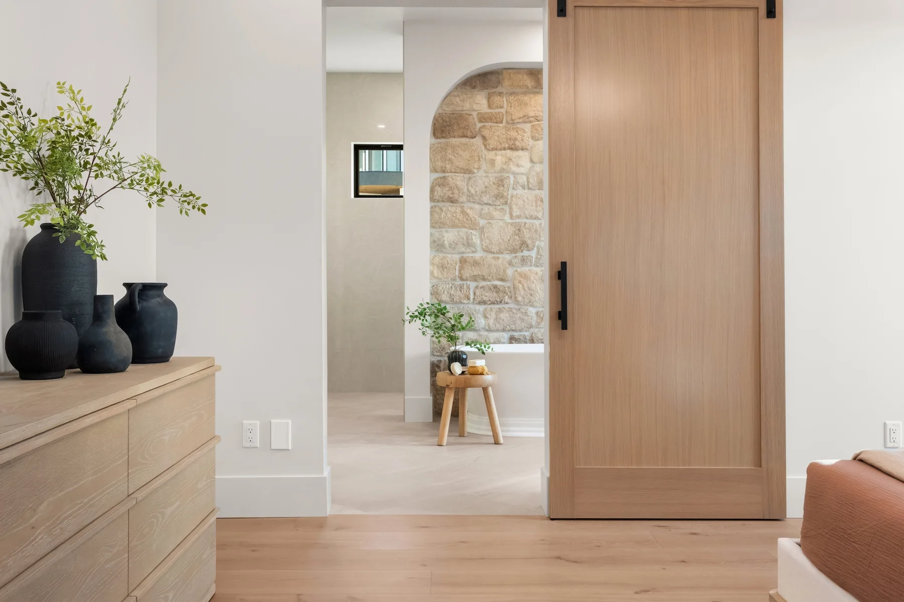 Wood paneled sliding in bathroom with stone accents